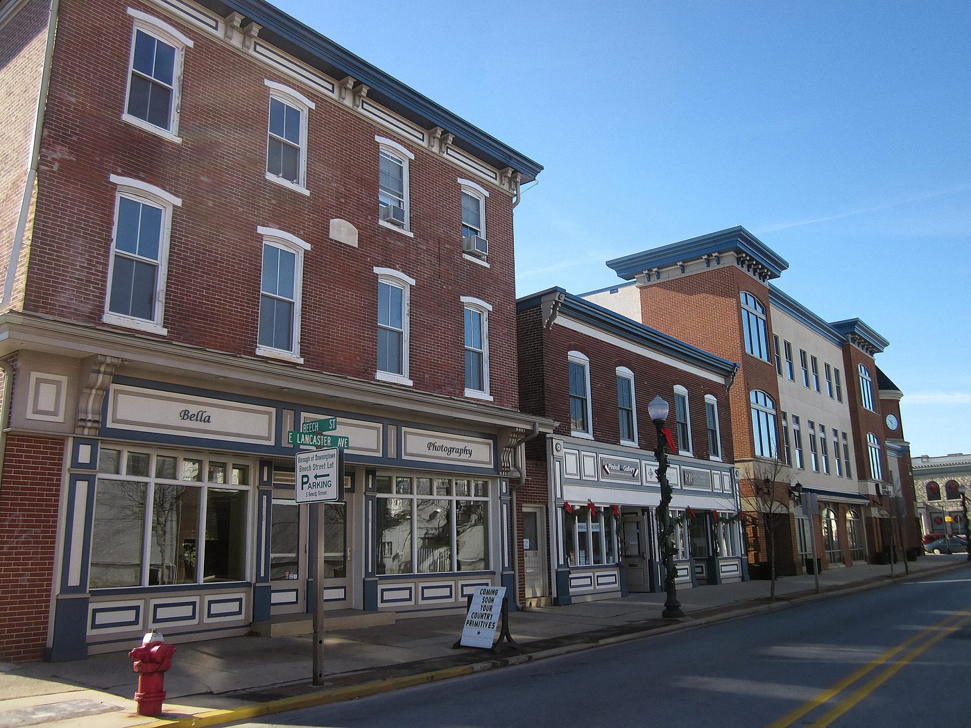 Lancaster Avenue in Downingtown. Brick three-storeys, storefronts at the pavement, apartments above them, and the ordinary purchase file behind every one.